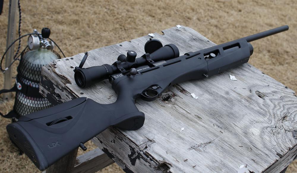 umarex gauntlet .25 caliber rifle laying on a shooting bench